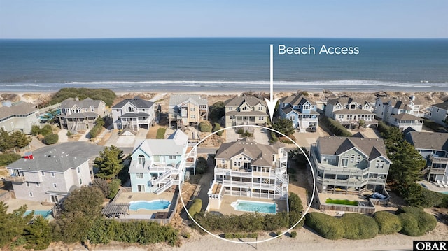 aerial view featuring a residential view, a water view, and a beach view