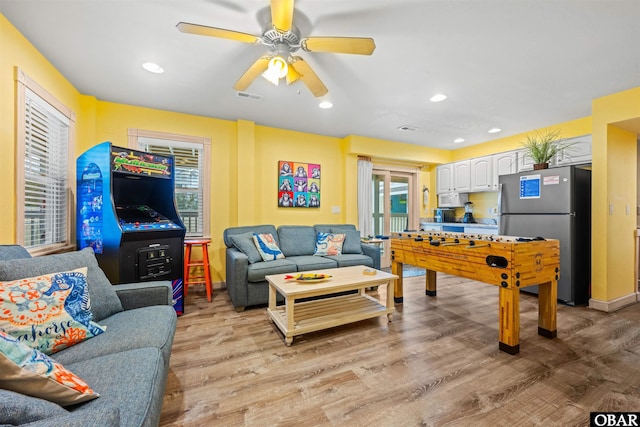 recreation room featuring ceiling fan, light wood-type flooring, visible vents, and recessed lighting