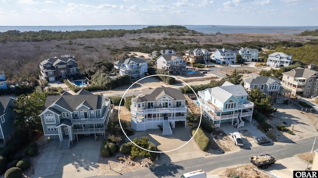 birds eye view of property with a residential view and a water view