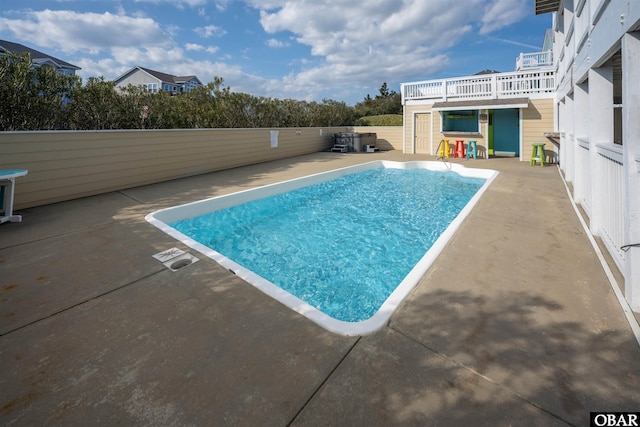 view of swimming pool featuring a fenced in pool and a patio