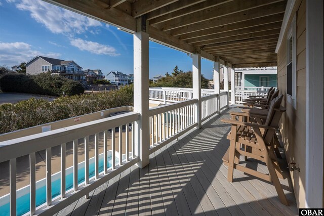 wooden deck featuring a fenced in pool