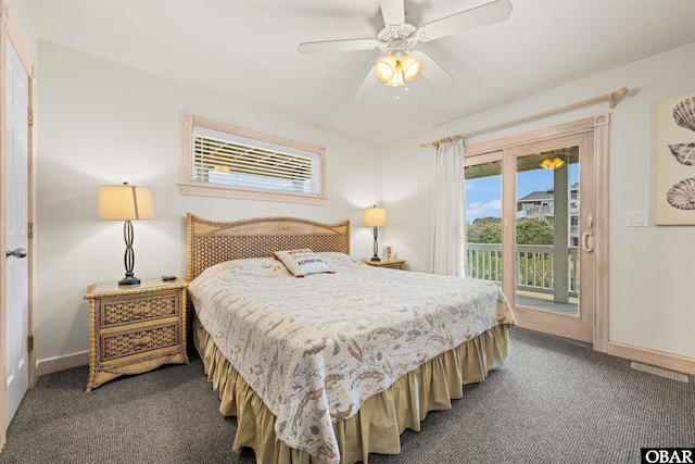 bedroom featuring baseboards, dark colored carpet, multiple windows, and access to exterior