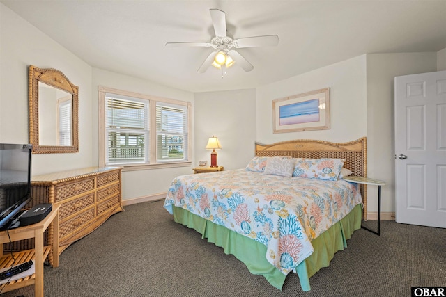 bedroom with ceiling fan, dark carpet, and baseboards