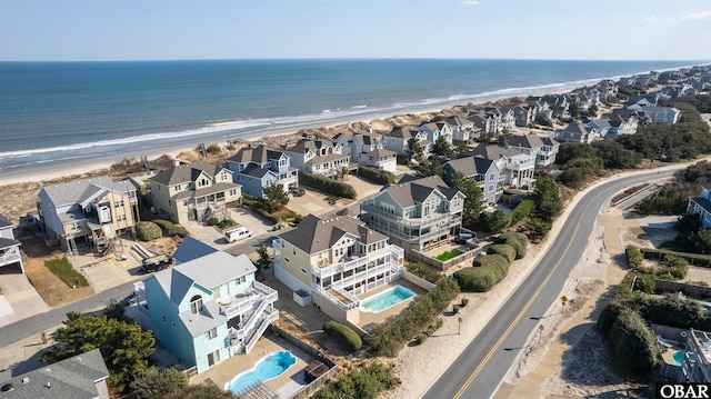 bird's eye view featuring a water view, a residential view, and a beach view