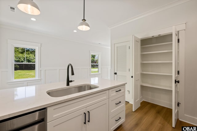517 Ananias Dare St Unit 4, Manteo, NC 27954 - kitchen featuring a sink, ornamental molding, light wood-type flooring, dishwasher, and white cabinets