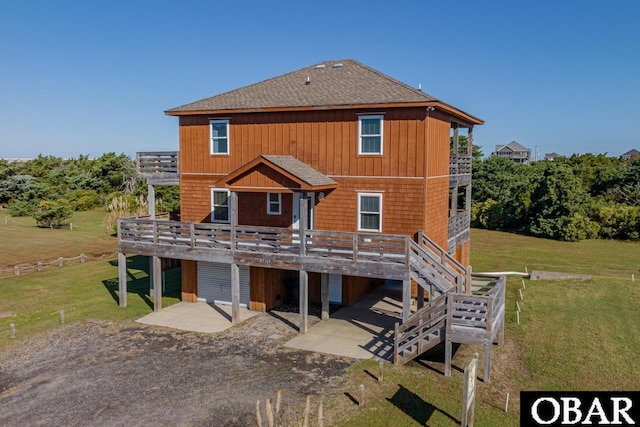 23183 Pappy Ln Lot 1B, Rodanthe, NC 27968 - back of property featuring a deck, a patio, driveway, roof with shingles, and a carport