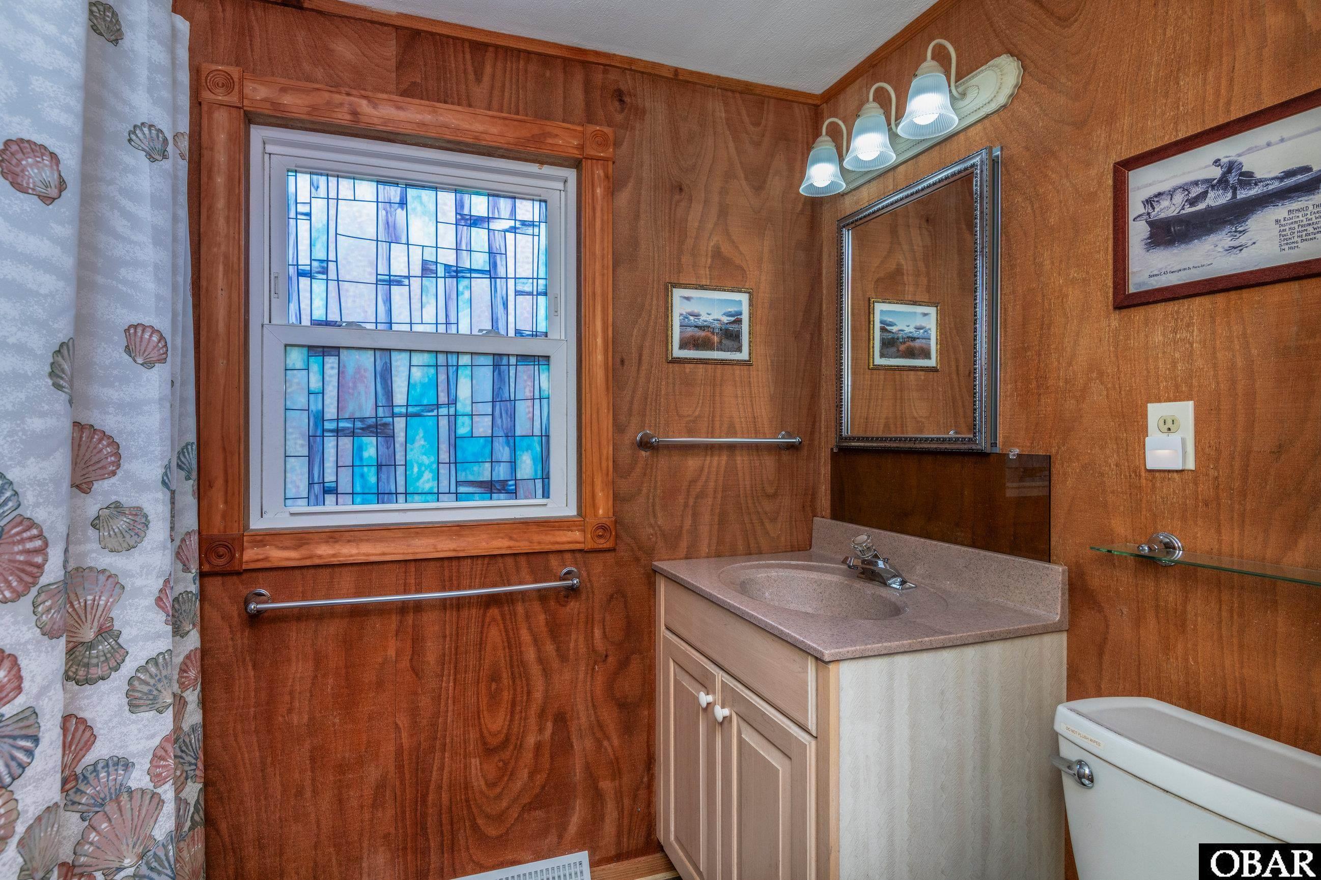 23193 W Corbina Dr Lot 24, Rodanthe, NC 27968 - bathroom featuring toilet, vanity, and wooden walls