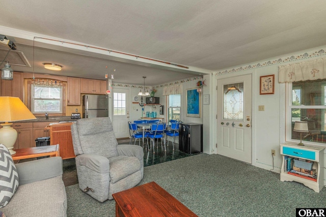 23193 W Corbina Dr Lot 24, Rodanthe, NC 27968 - living room featuring an inviting chandelier, carpet, and a textured ceiling