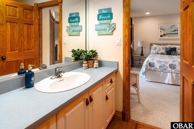 bathroom with recessed lighting, vanity, and ensuite bathroom