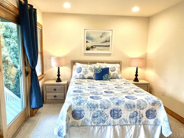 bedroom with recessed lighting, multiple windows, baseboards, and light colored carpet