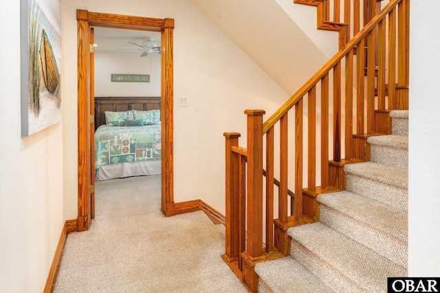 stairway with carpet floors and baseboards