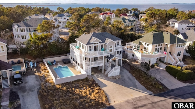 drone / aerial view with a water view and a residential view