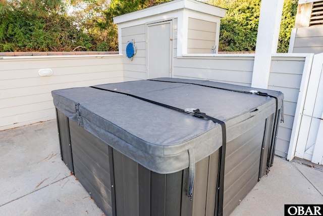 exterior space with fence and a jacuzzi