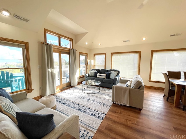 living area featuring visible vents and wood finished floors