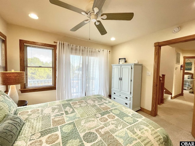 bedroom featuring recessed lighting, light colored carpet, and multiple windows