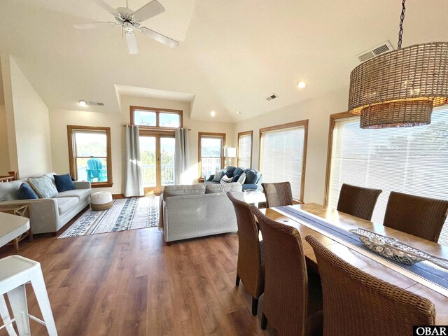 dining area featuring a wealth of natural light, dark wood-style flooring, visible vents, and ceiling fan