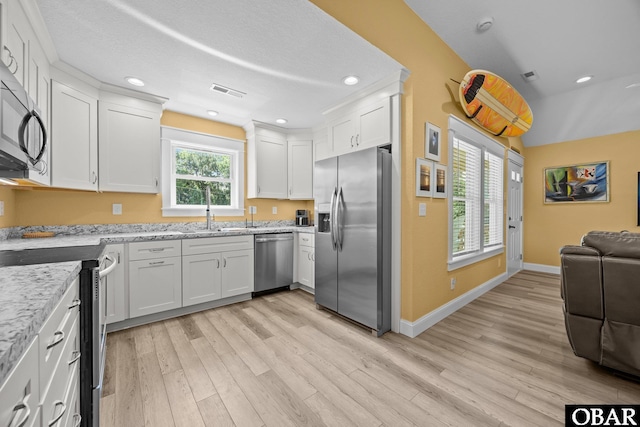1021 Harbour View Dr Lot 43, Kill Devil Hills, NC 27948 - kitchen featuring stainless steel appliances, white cabinetry, light wood finished floors, open floor plan, and recessed lighting