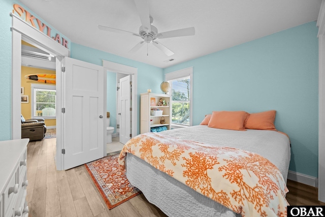 1021 Harbour View Dr Lot 43, Kill Devil Hills, NC 27948 - bedroom with light wood-style floors, a ceiling fan, and ensuite bathroom