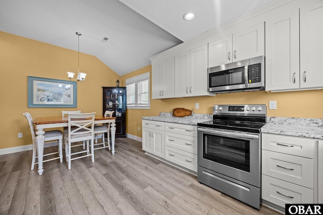1021 Harbour View Dr Lot 43, Kill Devil Hills, NC 27948 - kitchen with appliances with stainless steel finishes, vaulted ceiling, a chandelier, white cabinets, and light wood finished floors