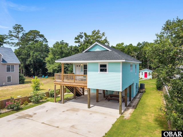 1021 Harbour View Dr Lot 43, Kill Devil Hills, NC 27948 - view of front of property with a carport, a front yard, a shingled roof, and driveway