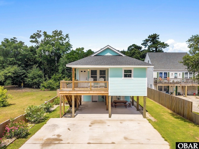 1021 Harbour View Dr Lot 43, Kill Devil Hills, NC 27948 - view of front of house with a carport, concrete driveway, and roof with shingles