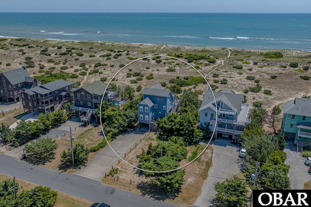 birds eye view of property featuring a water view and a residential view