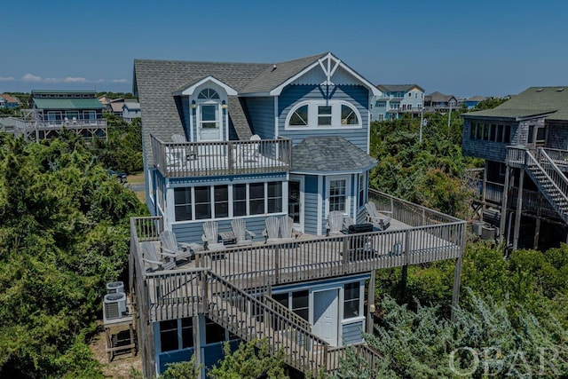 rear view of property featuring central air condition unit, roof with shingles, stairs, and a wooden deck