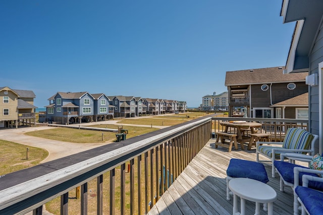 deck featuring a residential view and a lawn