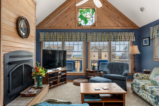 living room featuring lofted ceiling, carpet, and a fireplace