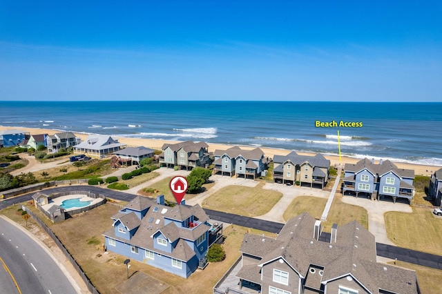 bird's eye view featuring a water view, a view of the beach, and a residential view