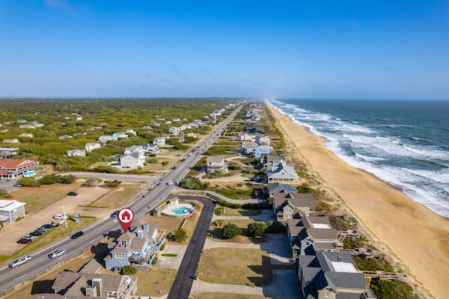 birds eye view of property with a water view, a residential view, and a beach view