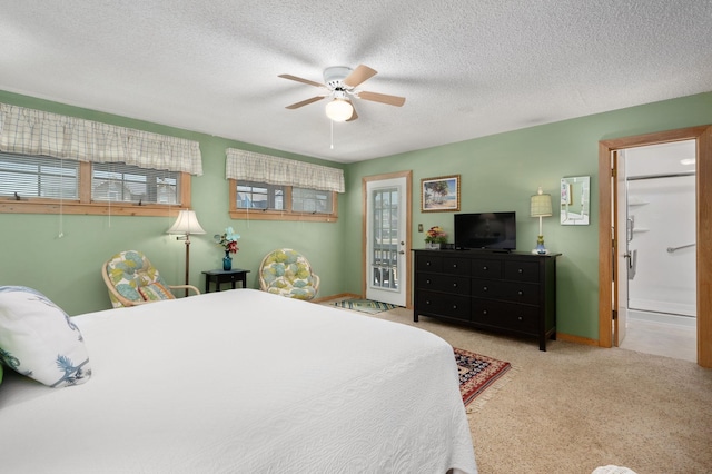 bedroom with a ceiling fan, light carpet, and a textured ceiling