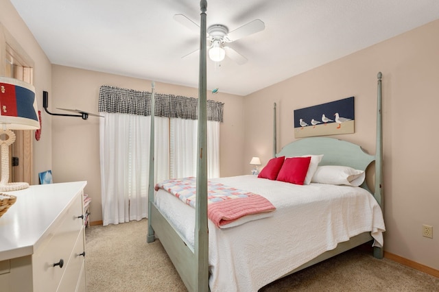 bedroom featuring light carpet, baseboards, and a ceiling fan