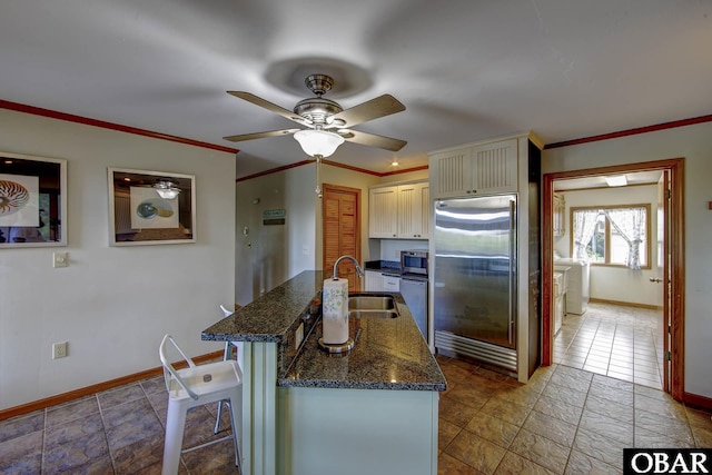 50050 Bayside Ct Lot 30, Frisco, NC 27936 - kitchen with appliances with stainless steel finishes, a sink, ceiling fan, baseboards, and dark stone countertops