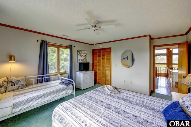 50050 Bayside Ct Lot 30, Frisco, NC 27936 - bedroom with carpet floors, multiple windows, a textured ceiling, ornamental molding, and a ceiling fan
