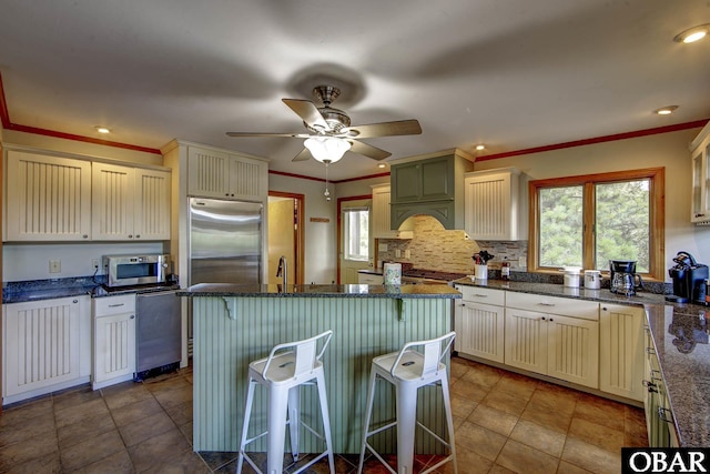 50050 Bayside Ct Lot 30, Frisco, NC 27936 - kitchen with appliances with stainless steel finishes, plenty of natural light, a kitchen bar, a ceiling fan, and recessed lighting