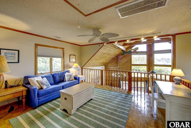 50050 Bayside Ct Lot 30, Frisco, NC 27936 - living room featuring a ceiling fan, healthy amount of natural light, a textured ceiling, and ornamental molding