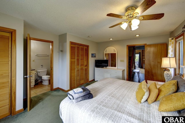 50050 Bayside Ct Lot 30, Frisco, NC 27936 - carpeted bedroom featuring baseboards, a textured ceiling, ceiling fan, and ensuite bath