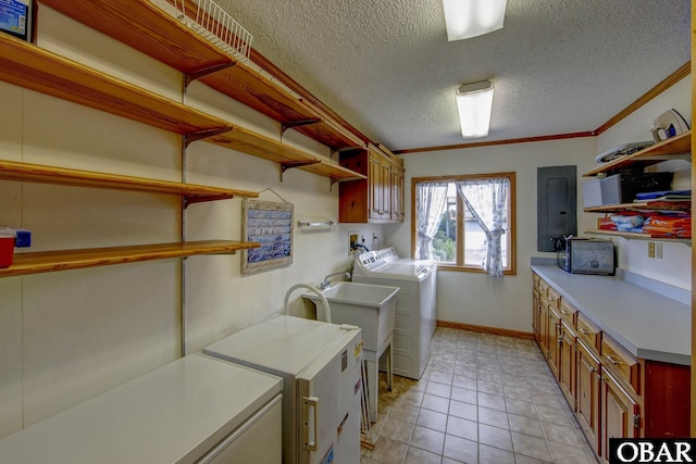 50050 Bayside Ct Lot 30, Frisco, NC 27936 - laundry room featuring cabinet space, washer and dryer, electric panel, a textured ceiling, and crown molding
