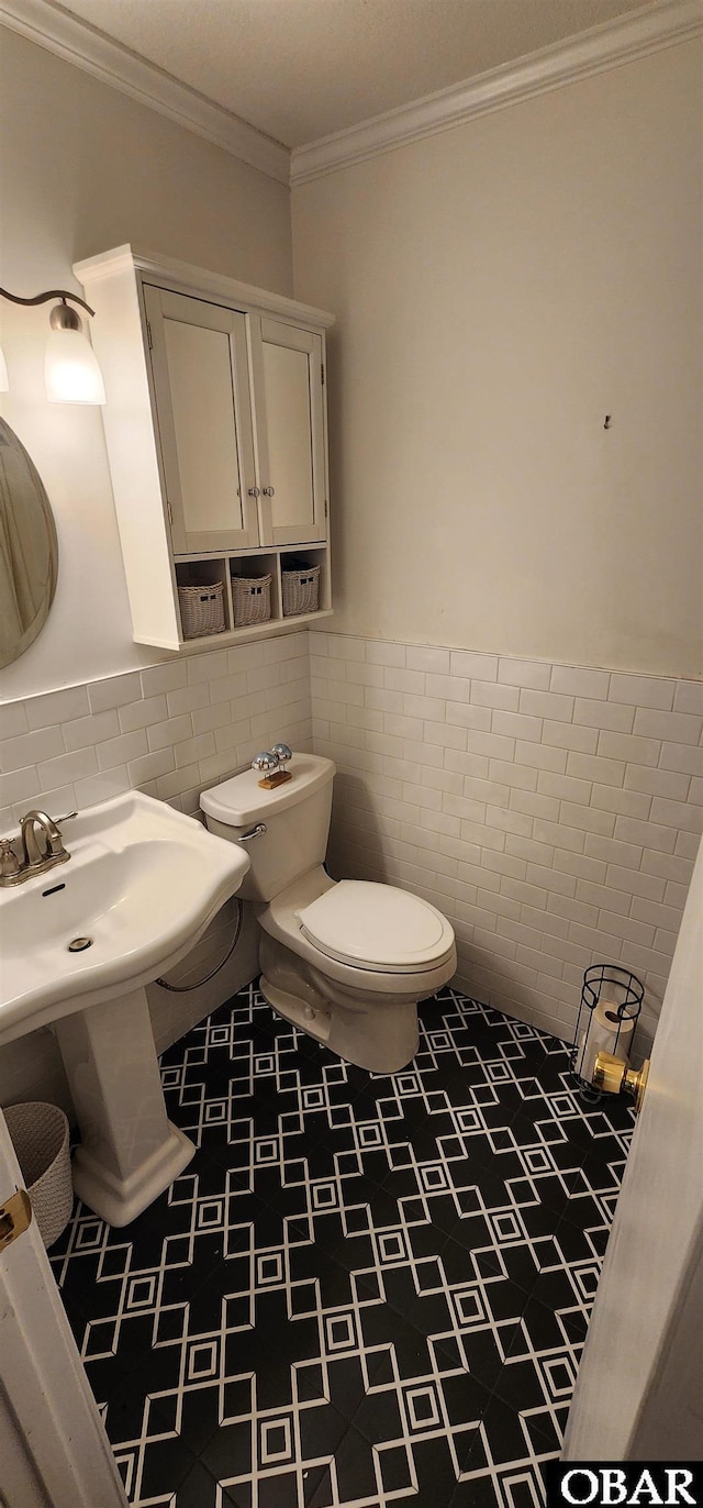 4327 S Hammerhead Dr Lot # 37, Nags Head, NC 27959 - bathroom with tile walls, toilet, wainscoting, and ornamental molding