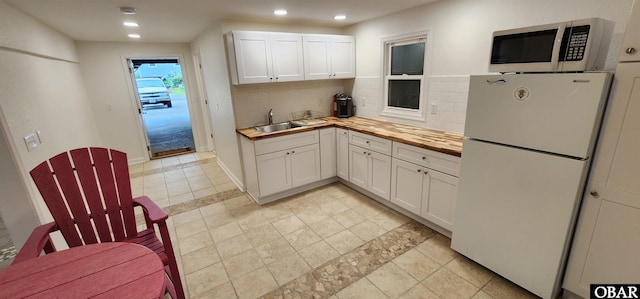 4327 S Hammerhead Dr Lot # 37, Nags Head, NC 27959 - kitchen featuring freestanding refrigerator, a sink, decorative backsplash, white cabinets, and recessed lighting