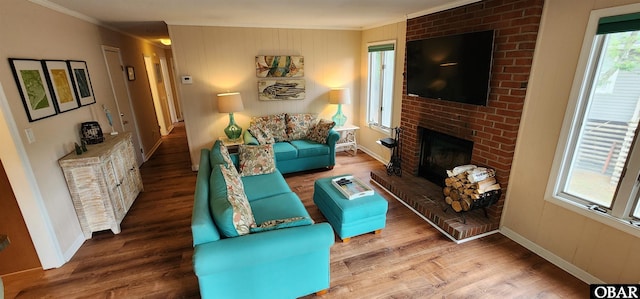 4327 S Hammerhead Dr Lot # 37, Nags Head, NC 27959 - living room featuring ornamental molding, wood finished floors, a brick fireplace, and baseboards