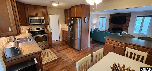 4327 S Hammerhead Dr Lot # 37, Nags Head, NC 27959 - kitchen featuring appliances with stainless steel finishes, open floor plan, a sink, crown molding, and dark wood-style floors