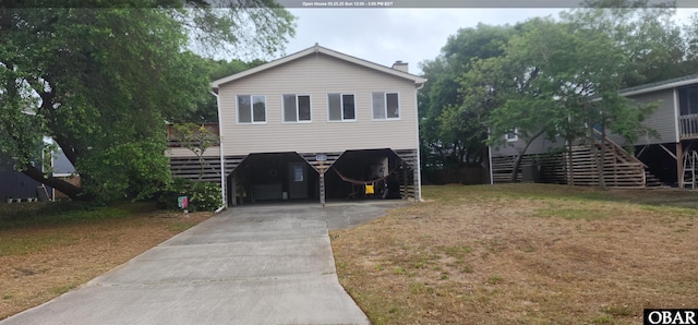 4327 S Hammerhead Dr Lot # 37, Nags Head, NC 27959 - raised beach house featuring stairway, a carport, driveway, and a chimney