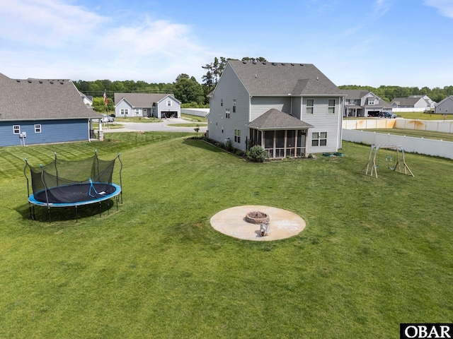 115 Sligo Way Lot 10, Moyock, NC 27958 - back of property featuring an outdoor fire pit, a trampoline, a sunroom, and a residential view