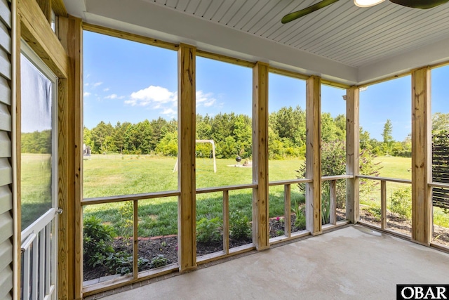 115 Sligo Way Lot 10, Moyock, NC 27958 - unfurnished sunroom featuring concrete flooring, ceiling fan, view of scattered trees, and plenty of natural light