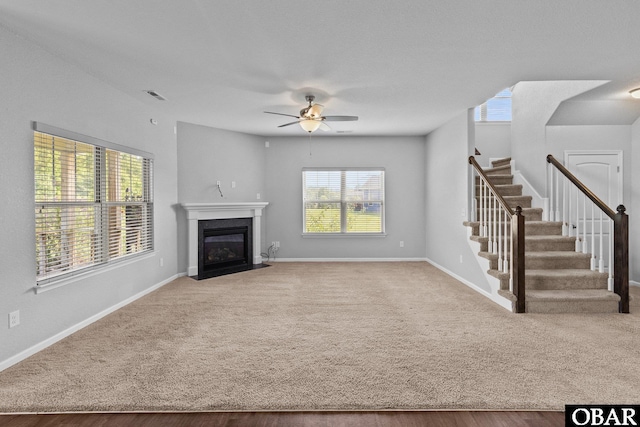 115 Sligo Way Lot 10, Moyock, NC 27958 - unfurnished living room featuring a ceiling fan, healthy amount of natural light, a fireplace with flush hearth, and stairway