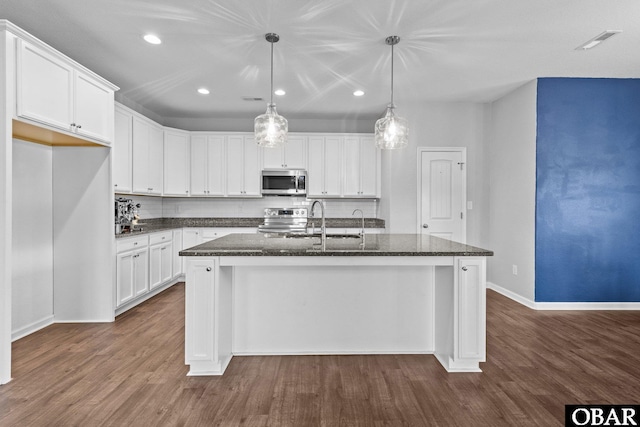 115 Sligo Way Lot 10, Moyock, NC 27958 - kitchen featuring appliances with stainless steel finishes, a center island with sink, recessed lighting, dark wood finished floors, and white cabinetry