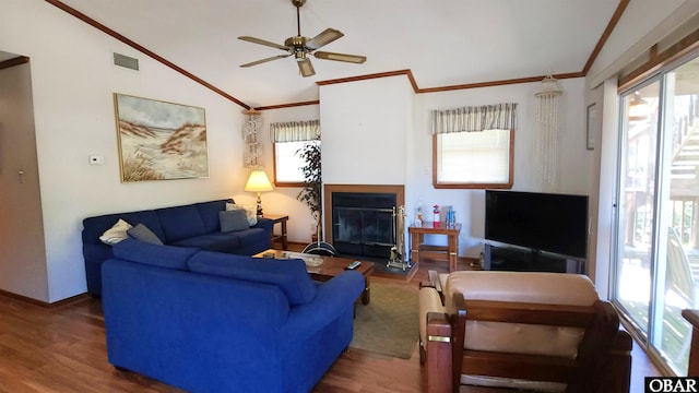 1809 Apache St Lot 3, Kill Devil Hills, NC 27948 - living area with crown molding, healthy amount of natural light, vaulted ceiling, a glass covered fireplace, and wood finished floors