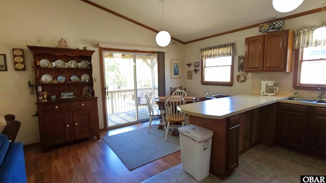 1809 Apache St Lot 3, Kill Devil Hills, NC 27948 - kitchen with healthy amount of natural light, lofted ceiling, a peninsula, light countertops, and wood finished floors